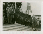 Sports - Banner - Group of men raising Tufts flag
