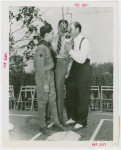 Sports - Baseball - Leo Durocher at microphone with boy scout and other man