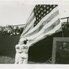 Sports - Baseball - Two baseball players raising flag