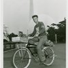 Sports - Bicycling - Man on bicycle with Trylon and Perisphere in background