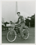 Sports - Bicycling - Man on bicycle with Trylon and Perisphere in background