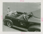 Sports - Ice Skating - Erma Anderson sitting on back of car