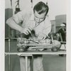 Sports - Midget Car Racing - Man tuning up model car