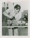 Sports - Midget Car Racing - Man tuning up model car