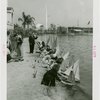 Sports - Miniature Boat Racing - Children launching model sailboats in water