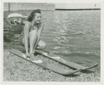 Sports - Waterskiing - Woman stepping into water-skis