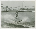 Sports - Waterskiing - Man on water-skis with woman on his shoulders
