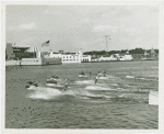 Sports - Waterskiing - Men on water-skis with women on their shoulders
