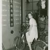 Standard Brands - Exhibits - Woman testing strength on electric bicycle exhibit