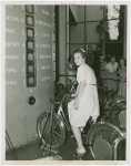 Standard Brands - Exhibits - Woman testing strength on electric bicycle exhibit