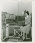 Tennessee Participation - Porter, Mary Nell (Maid of Cotton) - Sitting on railing with Fairgrounds in background