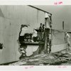 Textiles - Building - Fire - Man accessing scorched wall