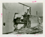 Textiles - Building - Fire - Man accessing scorched wall
