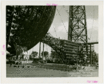 Theme Center - Trylon and Perisphere - Ceremonies - Chairs and stage set up for ceremony near framework of Trylon and Perisphere