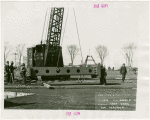 Theme Center - Trylon and Perisphere - Construction - Workers hoisting first steel frame for Perisphere