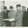 Theme Center - Trylon and Perisphere - Construction - Edward Stettinius, Jr. (U.S. Secretary of State) driving rivet into Perisphere while Grover Whalen and others look on