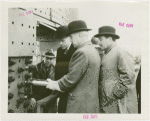 Theme Center - Trylon and Perisphere - Construction - Edward Stettinius, Jr. (U.S. Secretary of State) driving rivet into Perisphere while Grover Whalen and others look on
