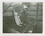 Theme Center - Trylon and Perisphere - Construction - Workers inspecting charred wiring