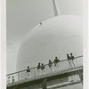 Theme Center - Trylon and Perisphere - Construction - Group watching man in harness painting Perisphere