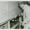 Theme Center - Trylon and Perisphere - Construction - Worker applying caulking compound to plywood