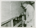 Theme Center - Trylon and Perisphere - Construction - Worker applying caulking compound to plywood