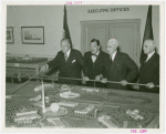 Theme Center - Trylon and Perisphere - Grover Whalen and Edward Stettinius, Jr. (U.S. Secretary of State) with others looking at Fair model