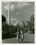 Theme Center - Trylon and Perisphere - View across grounds with two women in foreground