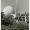 Theme Center - Trylon and Perisphere - View with two women in garden in foreground