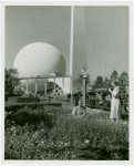 Theme Center - Trylon and Perisphere - View with two women in garden in foreground