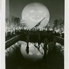 Theme Center - Trylon and Perisphere - Projected face on Perisphere at night