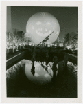 Theme Center - Trylon and Perisphere - Projected face on Perisphere at night