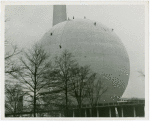 Theme Center - Trylon and Perisphere - Workers on Perisphere with Food Building in foreground