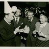 Ticket Sales - Fred Allen selling ticket books to woman and two men