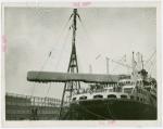 Trains - Shrouded train being lifted from ship