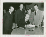 Turkey Participation - Münir Ertegün signing guestbook while others watch