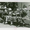 Typical American Family - Family eating hotdogs on bench