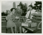 Typical American Family - Family eating hotdogs on bench