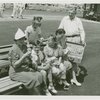 Typical American Family - Family eating lunch on bench