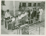 Typical American Family - Large family going through turnstile