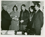 Typical American Family - Family receiving signed baseball and charm bracelet from Harvey Gibson