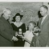 Typical American Family - Arvin family children receiving signed baseball and charm bracelet from Harvey Gibson