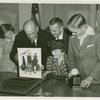 Typical American Family - Burdin family looking through photograph album with Harvey Gibson
