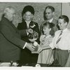 Typical American Family - Burnette family children receiving signed baseball and charm bracelet from Harvey Gibson