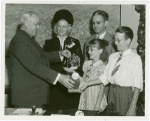 Typical American Family - Burnette family children receiving signed baseball and charm bracelet from Harvey Gibson
