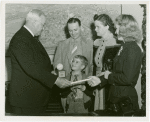 Typical American Family - Bollinger family children receiving signed baseball and charm bracelet from Harvey Gibson