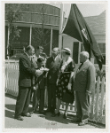 Typical American Family - Coleman family receiving key and lease from man while Harvey Gibson watches