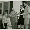 Typical American Family - Cramer family receiving key and lease from Harvey Gibson