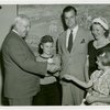 Typical American Family - Cramer family children receiving signed baseball and charm bracelet from Harvey Gibson