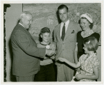 Typical American Family - Cramer family children receiving signed baseball and charm bracelet from Harvey Gibson