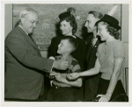 Typical American Family - Cole family children receiving signed baseball and charm bracelet from Harvey Gibson